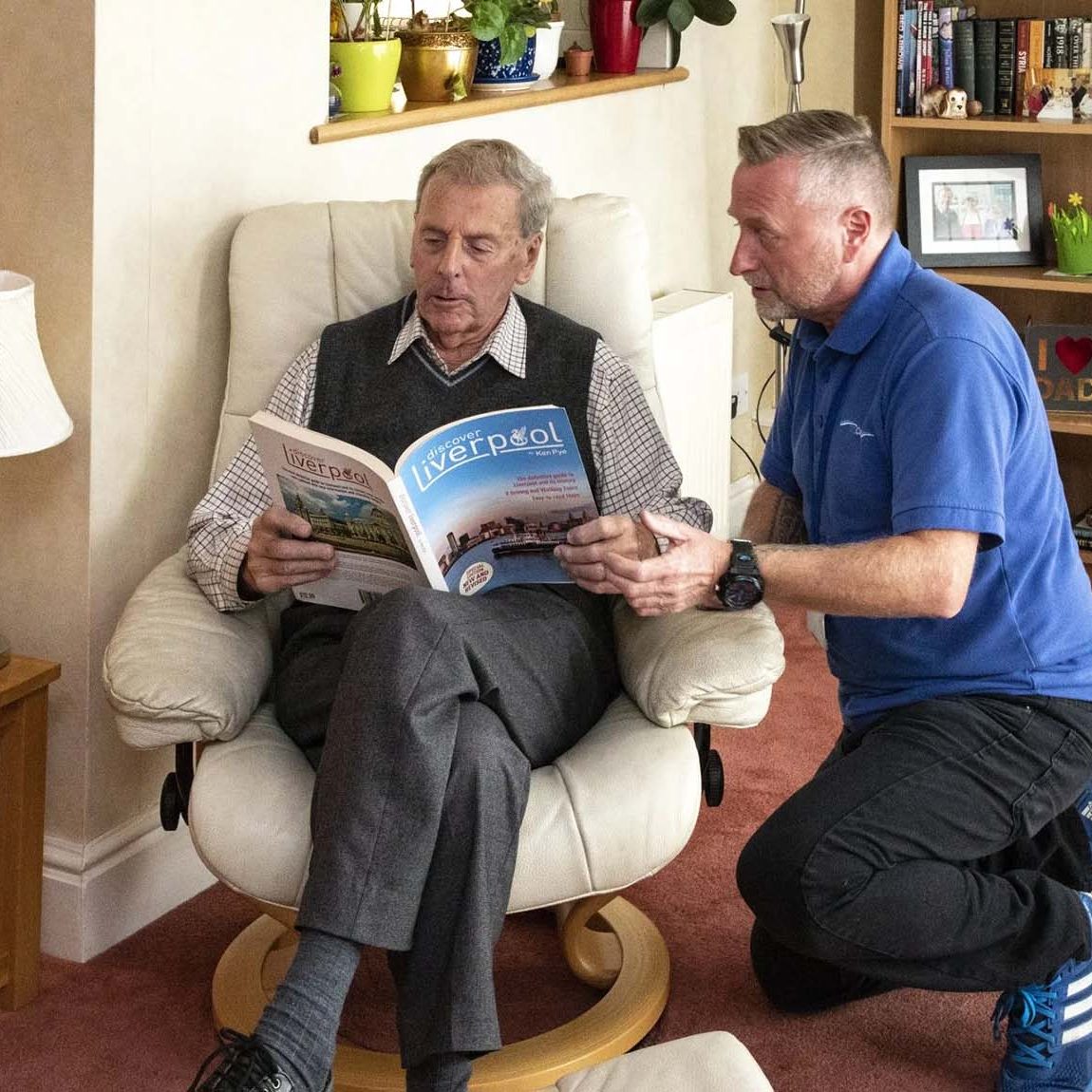 Elderly man getting help with his reading